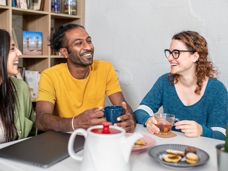 Three colleagues having tea and biscuits