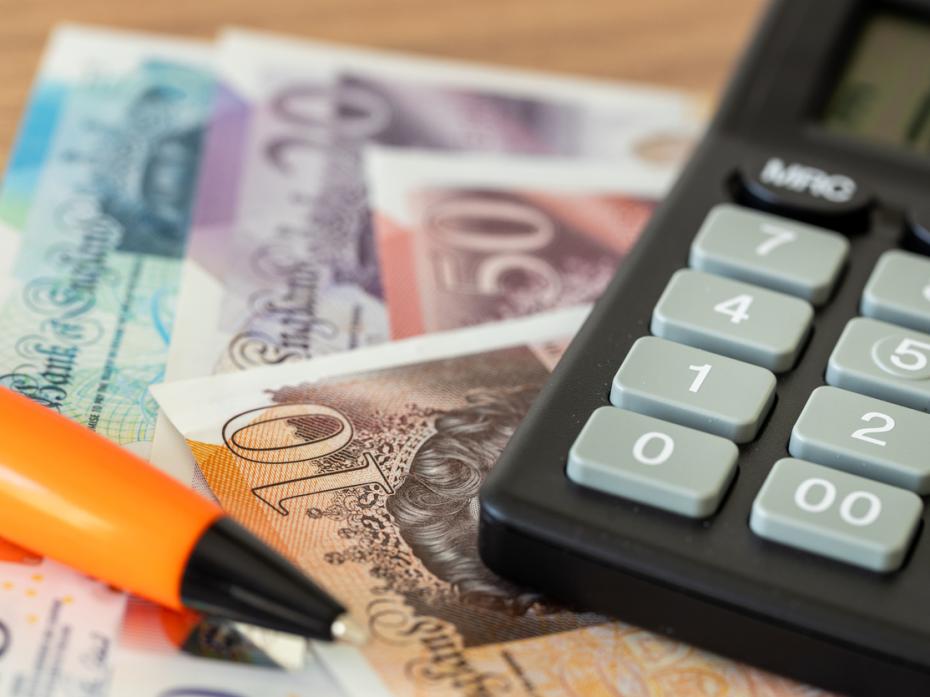 Money and a calculator on a table