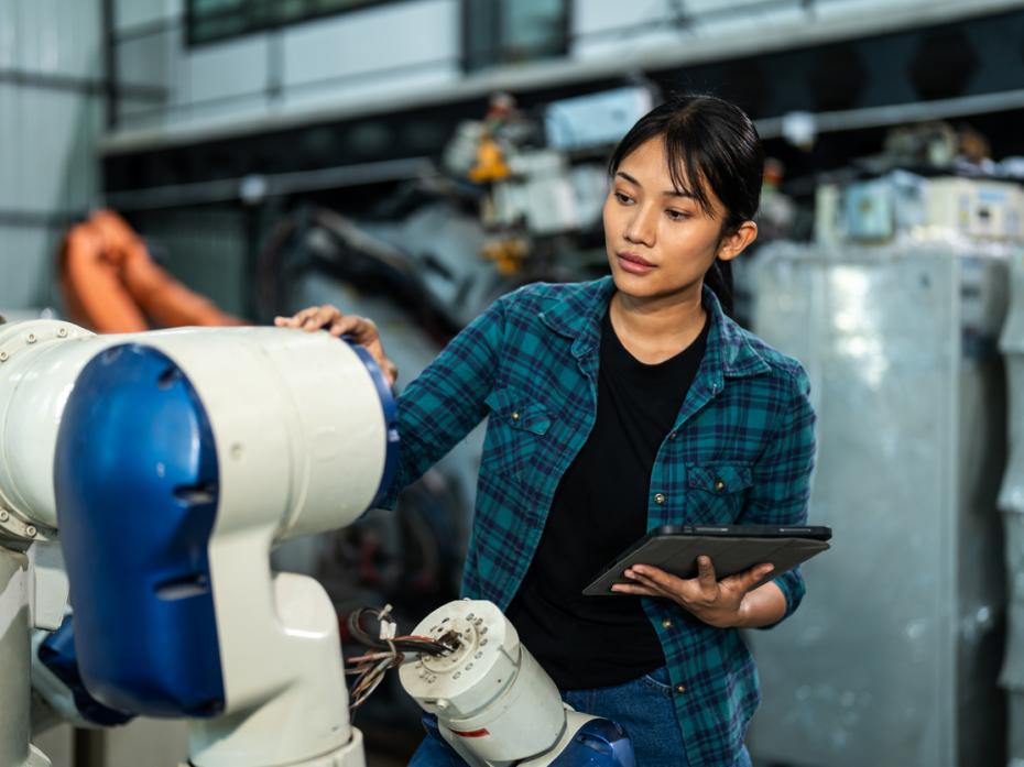 A woman building a robot