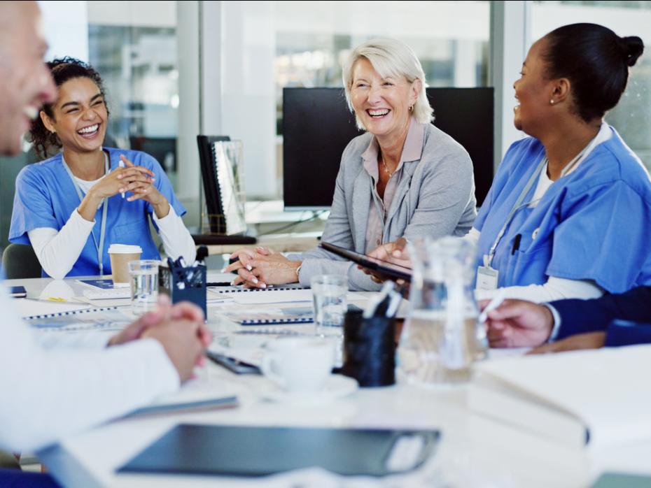 Doctors talking to non-medics around a table