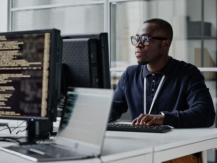 Young black man working at a computer terminal