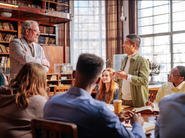 Academics sharing ideas in a university library
