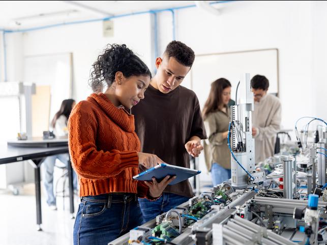 Students discussing a project in a lab
