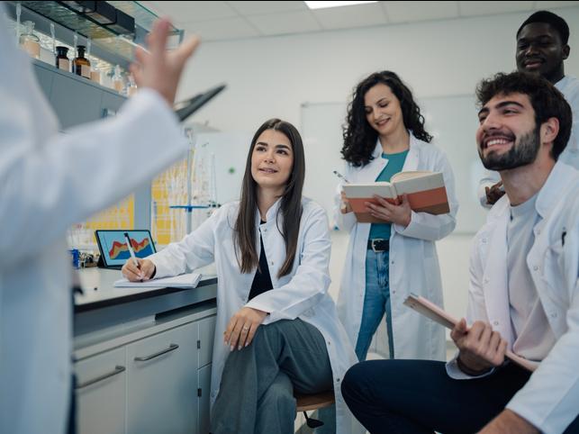 STEM students discuss ideas in a lab