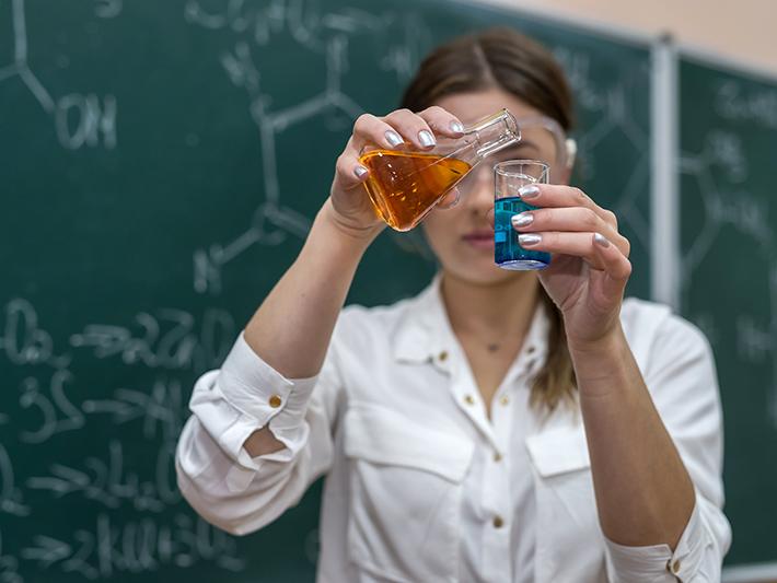 Female teacher doing chemistry demonstration