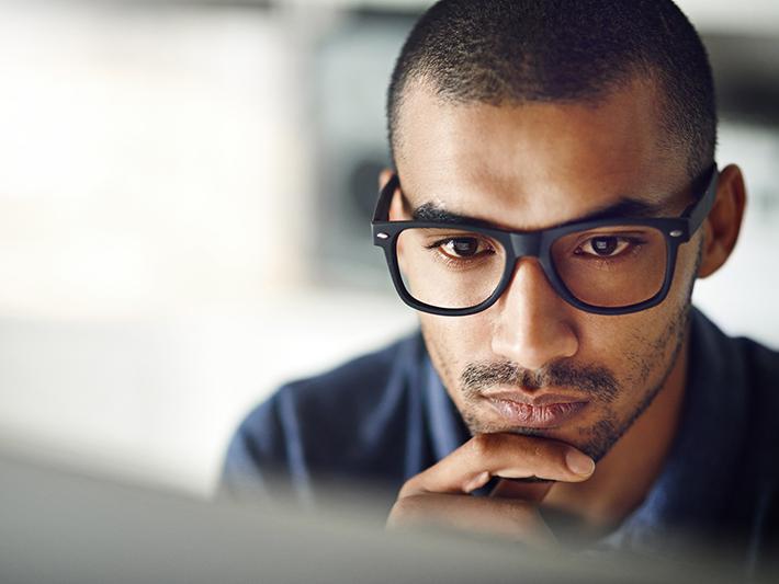 Young man looking at laptop