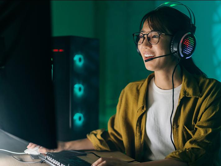 Young Asian woman gaming with headset on