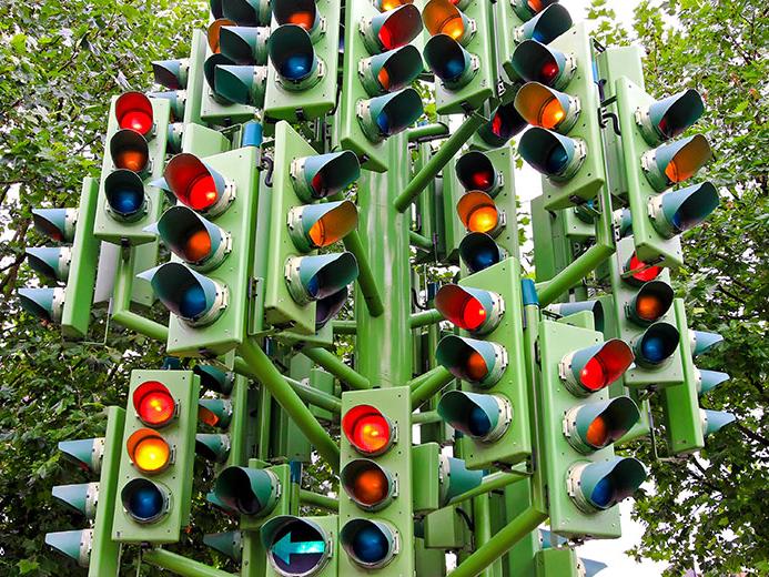 Lots of traffic lights mounted on single large pole