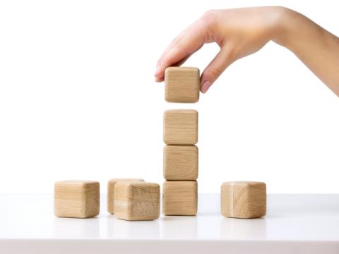 Hand stacking a column of blocks