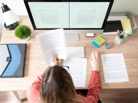 A student writing an essay at their desk