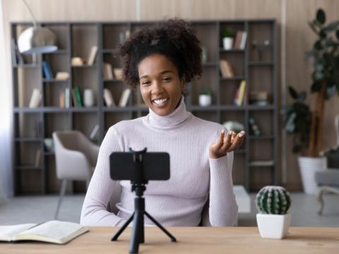 Young woman recording herself using a mobile phone