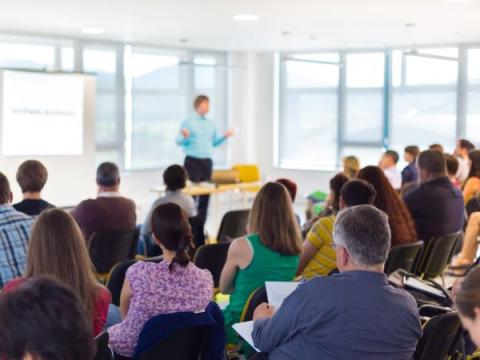 Image of a lecturer teaching a class of adult students