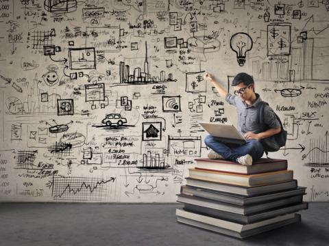 student on a pile of books with calculations on the wall concept