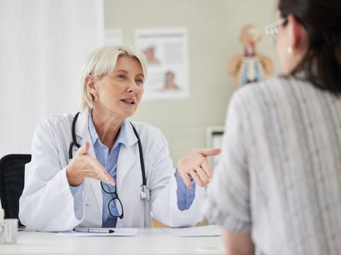 A female doctor talking to a woman