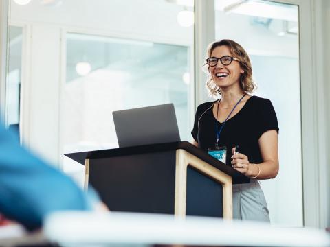 Woman speaking in front of room