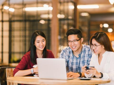 Asian students working at a laptop