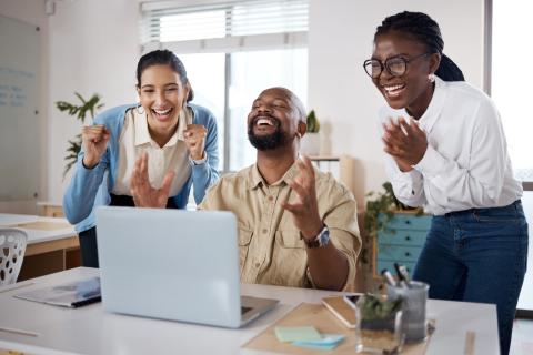 A team of colleagues celebrating a work success