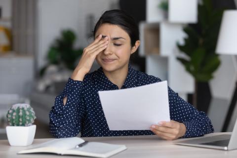 A young woman expressing disappointment over her work