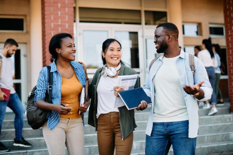 Students chatting to friends outside a university building