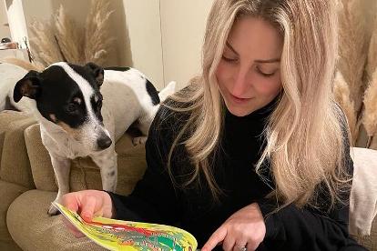 Women reading a storybook with a Jack Russell