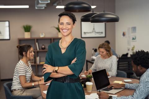 Female leader in an office smiling at the camera