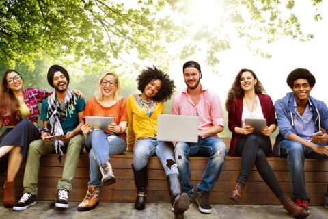 multiracial university students sitting outside