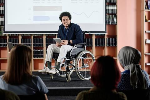 Man in wheelchair giving presentation