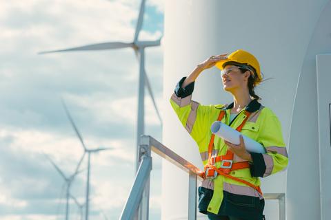 Young female engineer with wind turbines