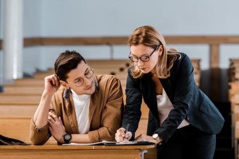 A teacher giving a student feedback 