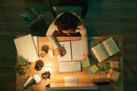 A woman working at a desk, viewed from above