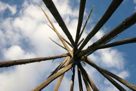 Structure of teepee against blue cloudy sky