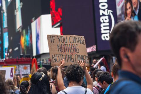 A placard at a climate change protest reads "if you change nothing, nothing changes"