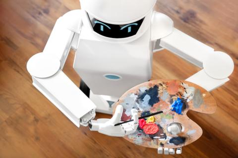 A robot holds a paint-splattered easel