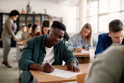 Students in an exam hall being assessed