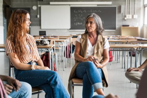 A teacher speaking to a student
