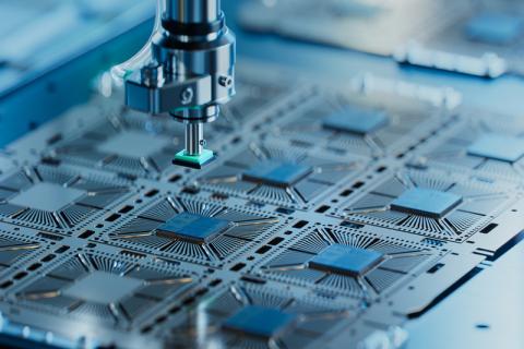 Close-up of silicon die are being extracted from semiconductor wafer