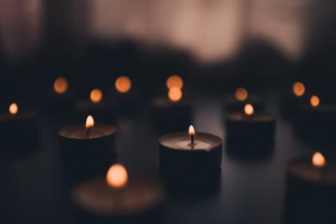 Lit candles in a darkened room