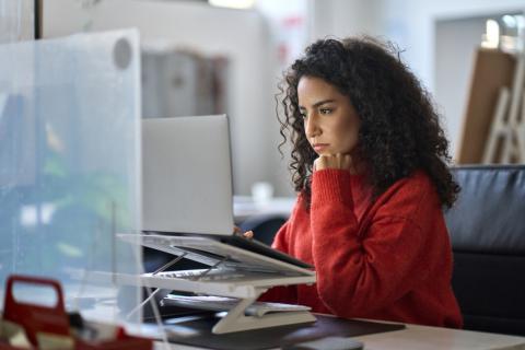 An academic conducting research on her laptop