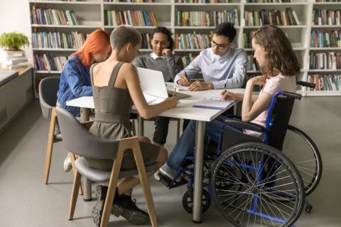 A group of students working on a project together in a classroom