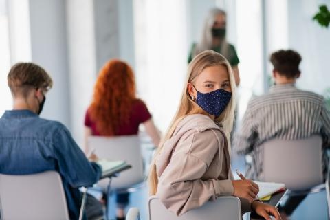Students wearing a mask in class to protect against viral infection
