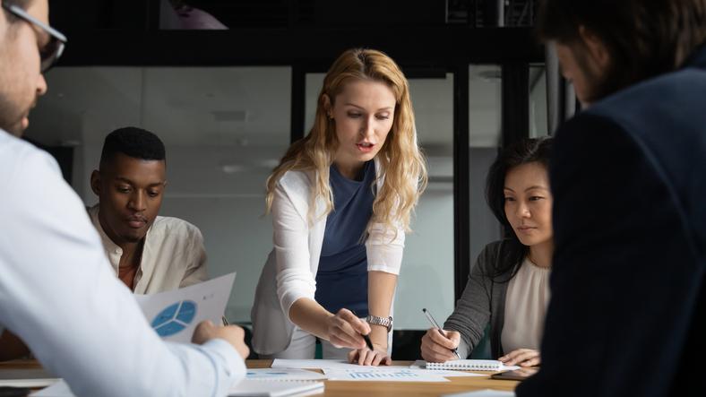 A group of people work around an office table