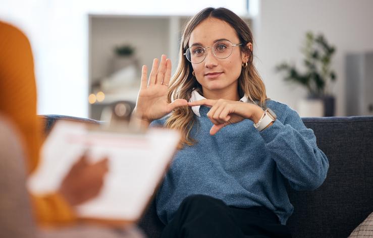 A young woman uses sign language