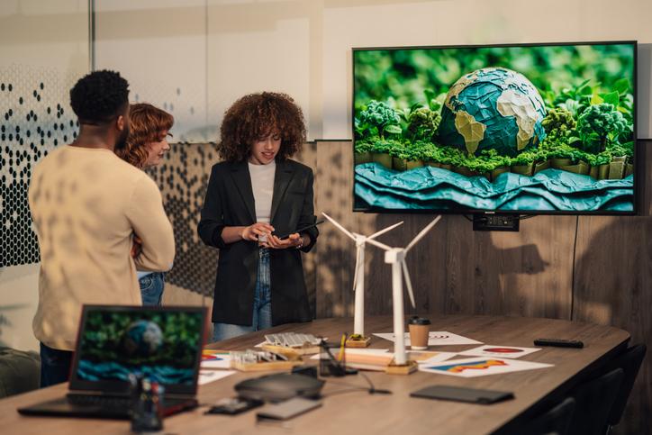 A presentation takes place on a screen featuring an illustration of the Earth