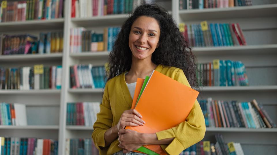 A female academic smiling to camera