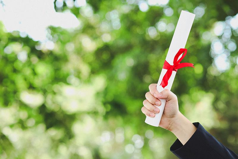 Hand holding university diploma