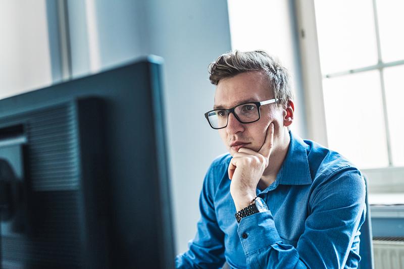 Male student concentrating at laptop