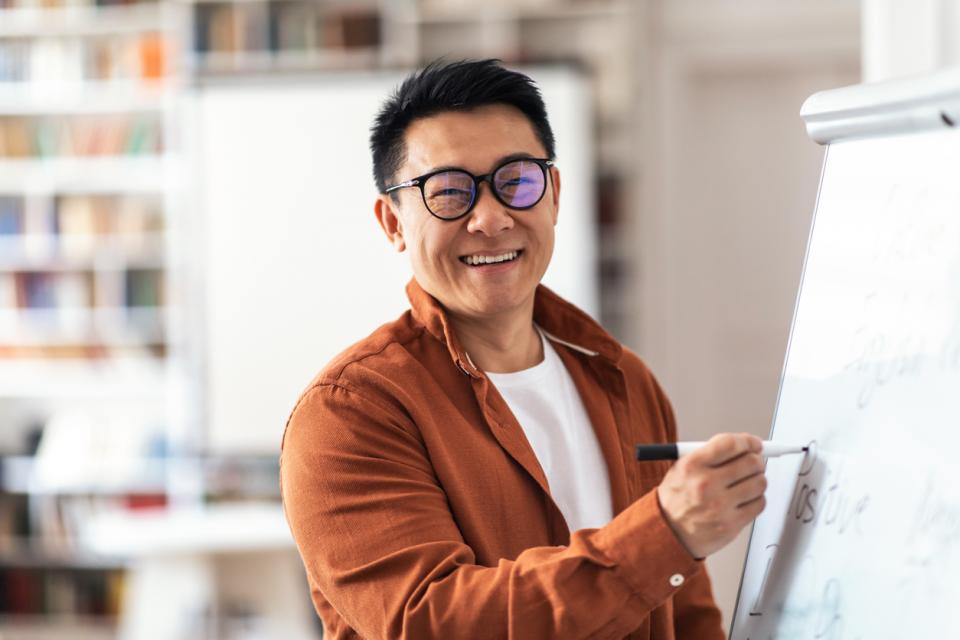 A professor writing on a whiteboard