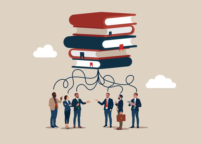 An illustration of a pile of books linking to a crowd of businesspeople