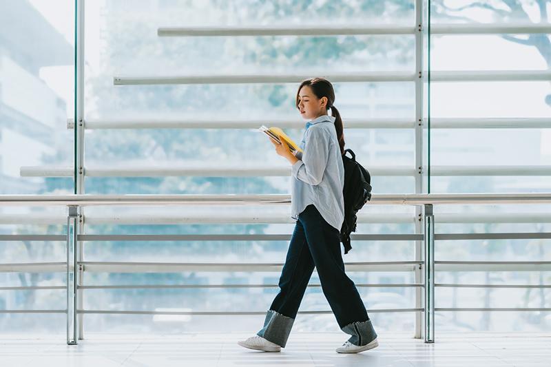 Female university student walking to class