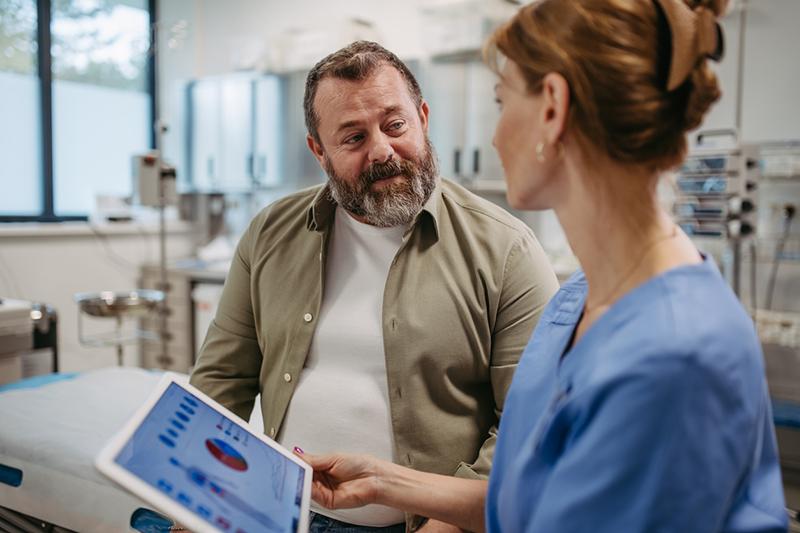 Middle-aged male patient with female doctor